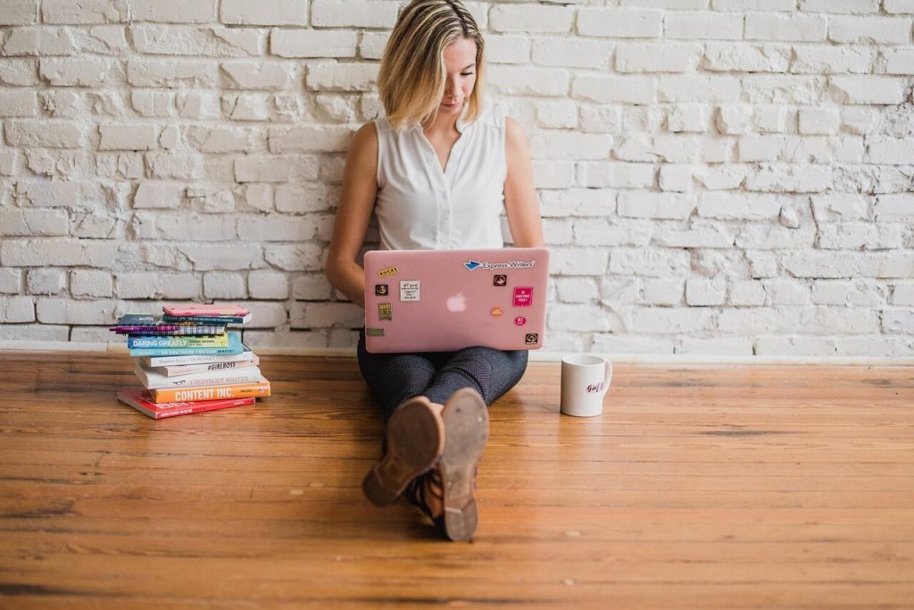 person sitting on floor with laptop
